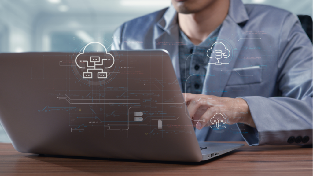 IP professional working on a laptop with cloud and data icons overlaid, representing the AppColl AI Assist chat assistant